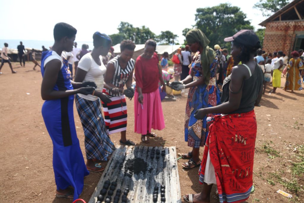 Trainees making hand molded briquettes