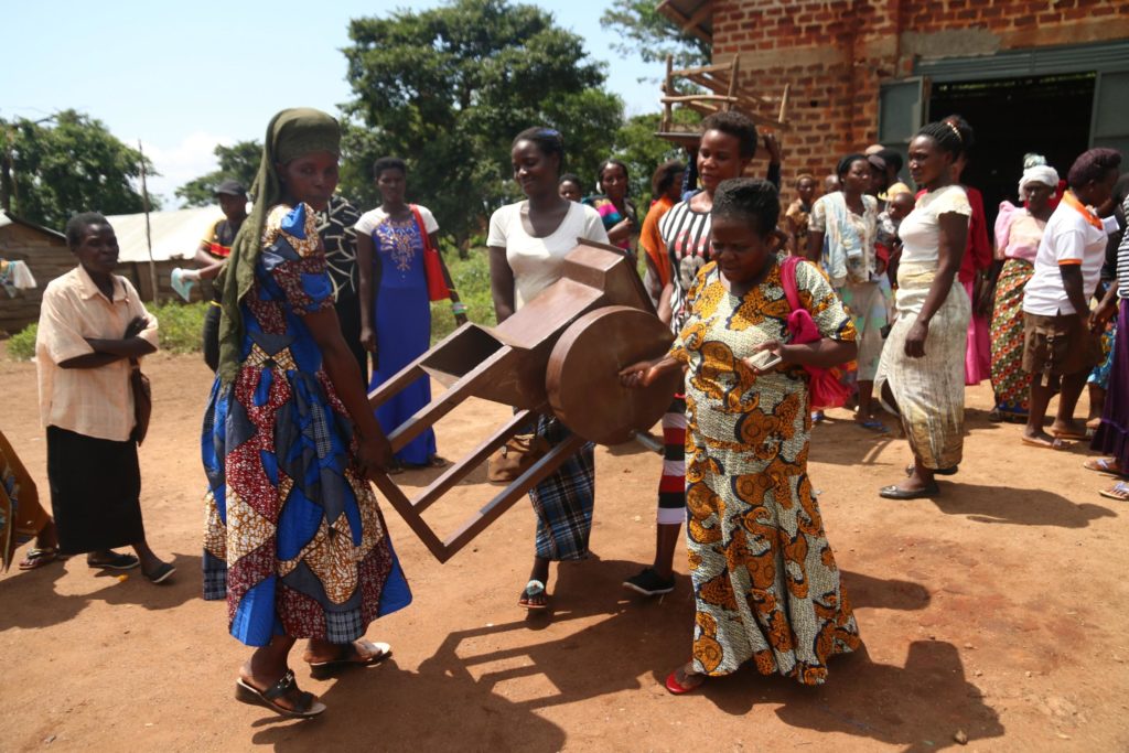 Women carrying manual crusher